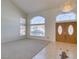 Bright, open-concept living area featuring neutral tones, plush carpeting, and large windows for natural light at 6 High Sierra Dr, Henderson, NV 89074