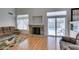 Living room features wood floors, a fireplace, and glass sliding door to backyard pool at 6 High Sierra Dr, Henderson, NV 89074