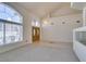 Bright, open-concept living area featuring neutral tones, plush carpeting, and large windows for natural light at 6 High Sierra Dr, Henderson, NV 89074