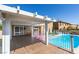 Covered patio with wood floors offers seamless indoor-outdoor living with views of the pool and backyard at 6 High Sierra Dr, Henderson, NV 89074