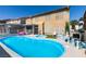 Beautiful backyard pool with a spa, surrounded by palm trees and lush landscaping at 6 High Sierra Dr, Henderson, NV 89074