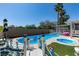 Beautiful backyard pool with a spa, surrounded by palm trees and lush landscaping at 6 High Sierra Dr, Henderson, NV 89074