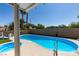 Inviting backyard pool with a sun deck, surrounded by palm trees and lush landscaping at 6 High Sierra Dr, Henderson, NV 89074