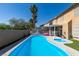 Inviting backyard pool with a sun deck, surrounded by palm trees and lush landscaping at 6 High Sierra Dr, Henderson, NV 89074
