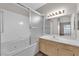 Well-lit bathroom showcasing a single sink vanity and shower-tub combination with sliding glass doors at 6480 Annie Oakley Dr # 112, Las Vegas, NV 89120