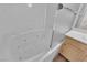 Close-up of a luxurious white soaking tub with jets, complemented by bright tiling and chrome finishes at 6480 Annie Oakley Dr # 112, Las Vegas, NV 89120