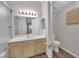 Bright bathroom features a white vanity with storage and a large mirror for a practical yet modern space at 6480 Annie Oakley Dr # 112, Las Vegas, NV 89120