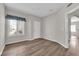 Corner bedroom features a window with wood flooring and neutral paint at 6480 Annie Oakley Dr # 112, Las Vegas, NV 89120