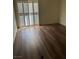 Bedroom featuring luxury vinyl flooring and sliding door access to a patio at 6480 Annie Oakley Dr # 112, Las Vegas, NV 89120