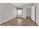Neutral bedroom with wood flooring, a shuttered window, and a walk-in closet at 6480 Annie Oakley Dr # 112, Las Vegas, NV 89120