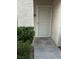 Front entryway door with security screen and small, mature landscaping at 6480 Annie Oakley Dr # 112, Las Vegas, NV 89120