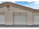 Garage doors of condo, offering convenient parking and storage in a well-maintained complex at 6480 Annie Oakley Dr # 112, Las Vegas, NV 89120