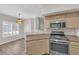 Bright kitchen featuring stainless steel appliances, light wood cabinets, and a stylish pendant light fixture at 6480 Annie Oakley Dr # 112, Las Vegas, NV 89120