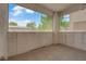 View of an open-air patio featuring textured walls and a glimpse of the community landscape beyond at 6480 Annie Oakley Dr # 112, Las Vegas, NV 89120