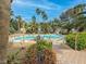 Community pool surrounded by lush palm trees and lounge chairs, offering a resort-like experience at 6480 Annie Oakley Dr # 112, Las Vegas, NV 89120