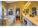 Bathroom featuring double sinks, tub, large vanity, and natural light at 6712 Tattler Dr, North Las Vegas, NV 89084