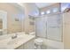 Functional bathroom with a single vanity, a toilet, and a shower with a sliding glass door at 6712 Tattler Dr, North Las Vegas, NV 89084