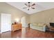 Cozy bedroom featuring hardwood floors, a comfortable sofa, and ample natural light at 6712 Tattler Dr, North Las Vegas, NV 89084
