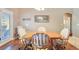 Cozy dining area with hardwood floors, a wooden table, four chairs, and a door to the backyard at 6712 Tattler Dr, North Las Vegas, NV 89084
