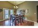 Dining room with a wood table and views of the pool outside at 6712 Tattler Dr, North Las Vegas, NV 89084