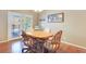 Cozy dining area with hardwood floors, a wooden table, four chairs, and French doors at 6712 Tattler Dr, North Las Vegas, NV 89084