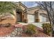 Close up of a single-story home featuring a well-manicured front yard and a two-car garage at 6712 Tattler Dr, North Las Vegas, NV 89084