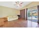Bright living room with hardwood floors, a sofa, and a sliding glass door overlooking the pool at 6712 Tattler Dr, North Las Vegas, NV 89084