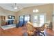 Bright living and dining area features vaulted ceilings, hardwood floors, a ceiling fan, and access to the backyard at 6712 Tattler Dr, North Las Vegas, NV 89084