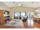 Bright living room features vaulted ceilings, hardwood floors, a ceiling fan, and furniture at 6712 Tattler Dr, North Las Vegas, NV 89084