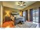 Main bedroom with vaulted ceiling, ceiling fan, and sliding glass door to patio at 6712 Tattler Dr, North Las Vegas, NV 89084