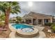 Backyard pool and hot tub surrounded by a fenced in yard, perfect for entertaining and relaxation at 6712 Tattler Dr, North Las Vegas, NV 89084