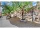 Landscaped backyard with gravel bed and rock wall offer a tranquil setting and shade trees at 6739 Quapaw St, Las Vegas, NV 89149