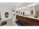 Spacious bathroom with double sinks, granite counters, and a large mirror at 6739 Quapaw St, Las Vegas, NV 89149