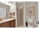 Modern bathroom featuring a glass shower, granite counters, framed art and neutral colors at 6739 Quapaw St, Las Vegas, NV 89149
