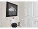 Stylish powder room with framed art, toilet, and door, creating a modern and inviting space at 6739 Quapaw St, Las Vegas, NV 89149