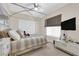 Inviting bedroom with natural light, light colored carpet, and a canopy bed at 6739 Quapaw St, Las Vegas, NV 89149