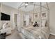 Comfortable bedroom featuring a four poster bed, ensuite bathroom, and neutral tones at 6739 Quapaw St, Las Vegas, NV 89149