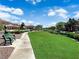 Beautiful community park featuring lush green grass and a walking path, perfect for outdoor enjoyment at 6739 Quapaw St, Las Vegas, NV 89149