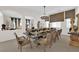 Formal dining room with a large table set for a dinner party under a chandelier at 6739 Quapaw St, Las Vegas, NV 89149