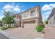 Inviting two-story home with a brick driveway and a well-manicured front yard at 6739 Quapaw St, Las Vegas, NV 89149