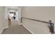 Hallway featuring a decorative railing and leading to an area with abundant natural light at 6739 Quapaw St, Las Vegas, NV 89149