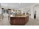 Kitchen island with sink, granite countertops, stainless appliances and wood cabinets at 6739 Quapaw St, Las Vegas, NV 89149