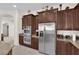 Gourmet kitchen boasts stainless steel appliances and rich wood cabinetry at 6739 Quapaw St, Las Vegas, NV 89149