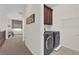Convenient laundry area with modern washer and dryer, storage cabinets, and easy access from the hallway at 6739 Quapaw St, Las Vegas, NV 89149