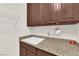 Functional laundry room with granite countertop, sink, and ample storage cabinets, perfect for household chores at 6739 Quapaw St, Las Vegas, NV 89149