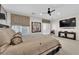 Comfortable main bedroom featuring a ceiling fan, TV, and a sliding glass door at 6739 Quapaw St, Las Vegas, NV 89149