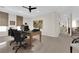 Spacious home office with a large desk, modern decor, and access to a hallway, perfect for working from home at 6739 Quapaw St, Las Vegas, NV 89149