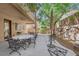 A spacious outdoor patio features elegant patio furniture and a stone retaining wall beyond at 6739 Quapaw St, Las Vegas, NV 89149