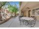 Expansive patio with stylish seating, perfect for outdoor gatherings and relaxation with a stone retaining wall at 6739 Quapaw St, Las Vegas, NV 89149