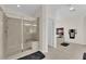 Bathroom featuring a glass-enclosed shower with a built-in bench and modern fixtures at 6739 Quapaw St, Las Vegas, NV 89149